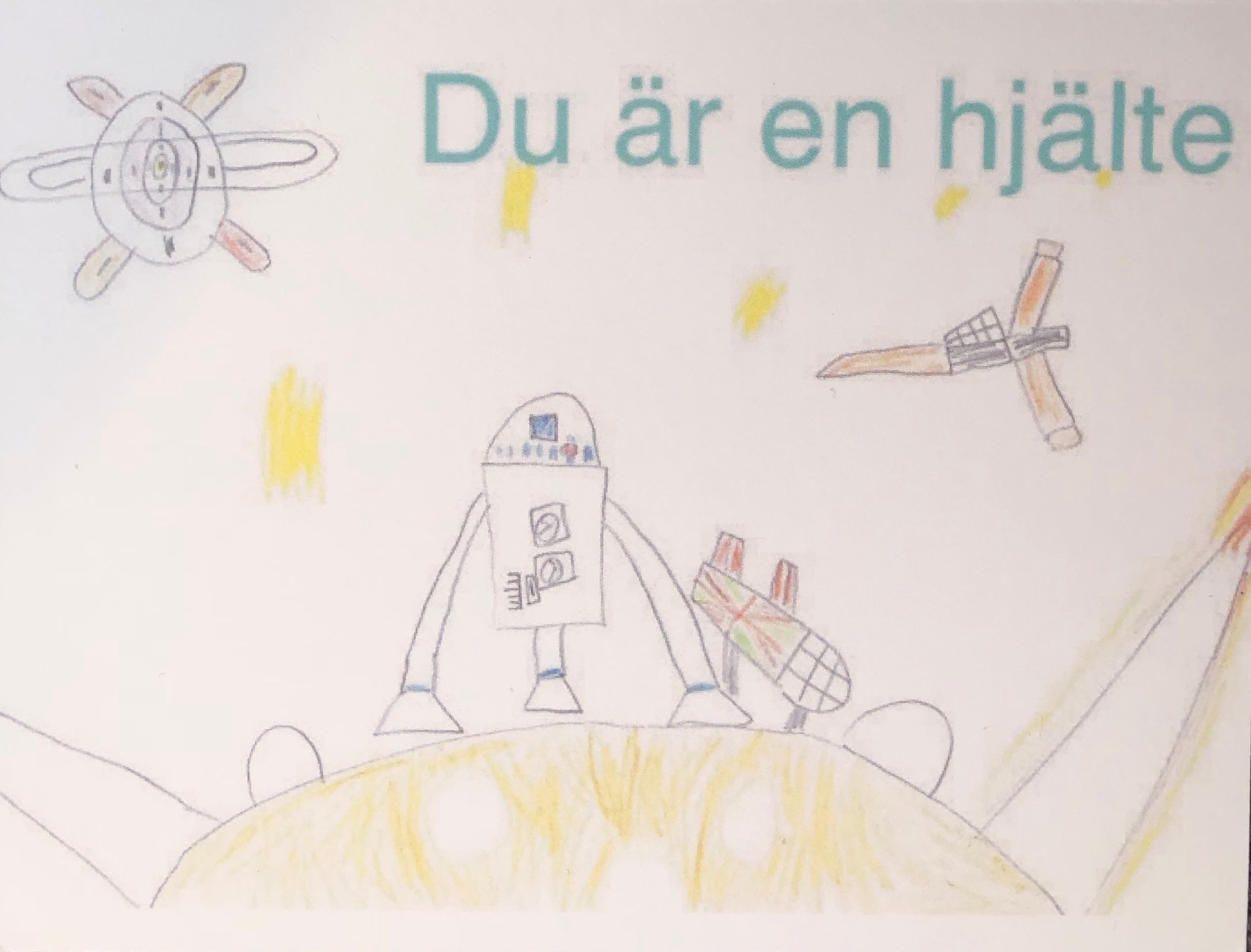 Ett kort skapat av våra unga konstnärer, med texten "Du är en hjälte". Motivet är en raketer och rymdfarkoster.